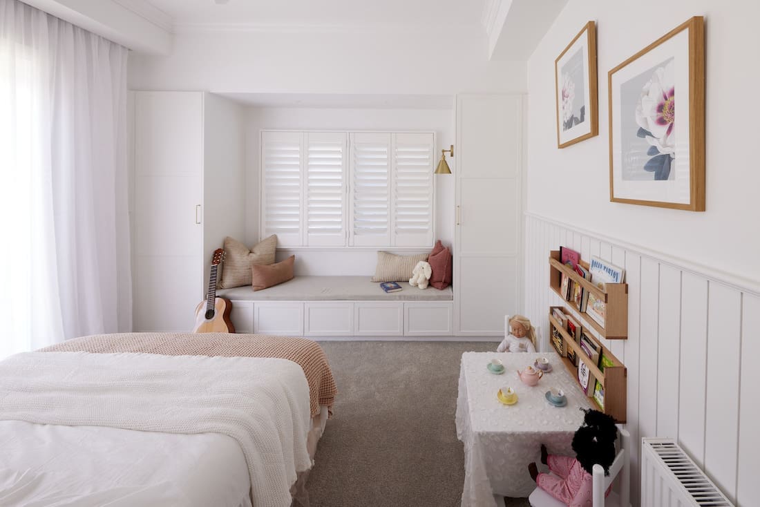 Girls bedroom with built in window seat