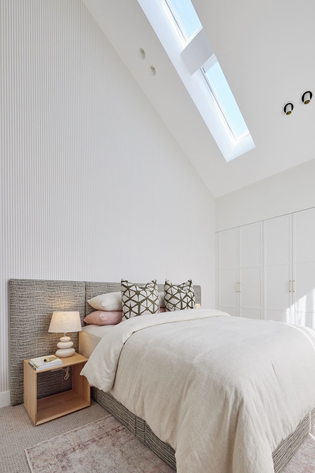 Bedroom with fabric bedhead and skylights