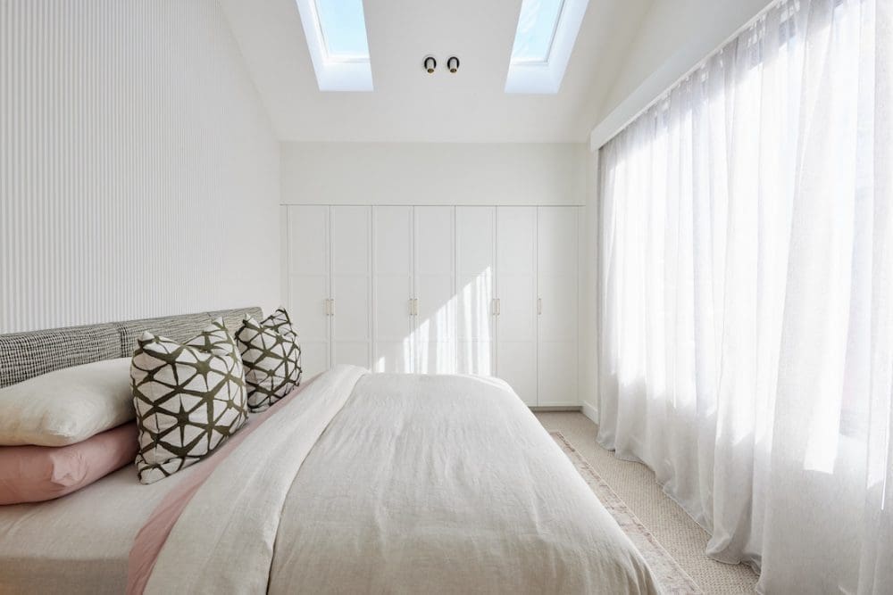 Bedroom with skylights and built-in wardrobe