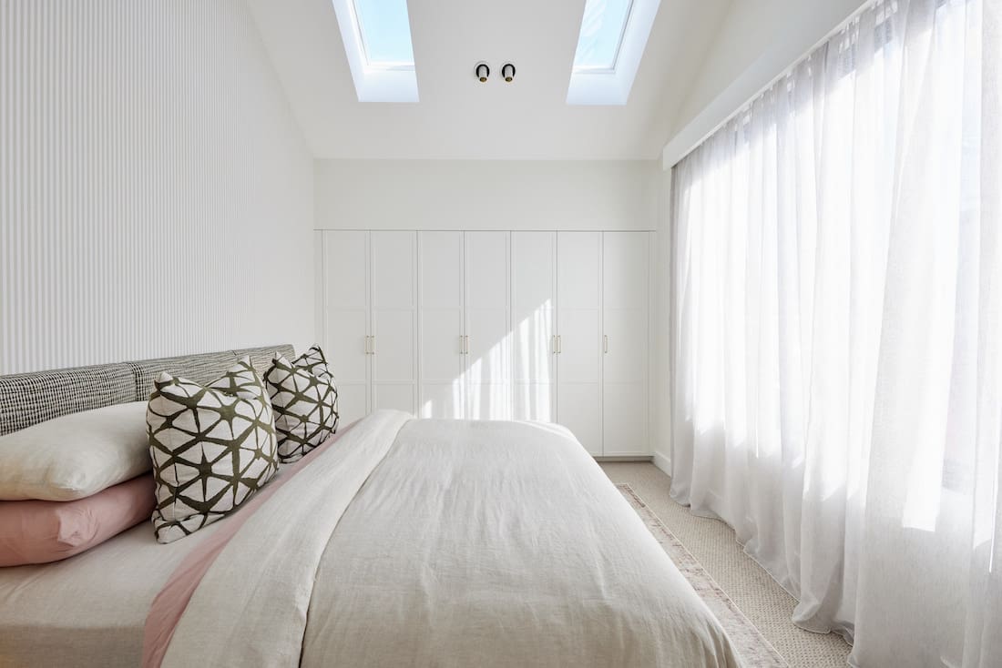 Bedroom with skylights and built-in wardrobe