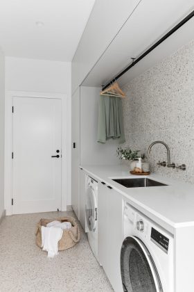 Tonal terrazzo laundry: Modern laundry renovation with a retro twist