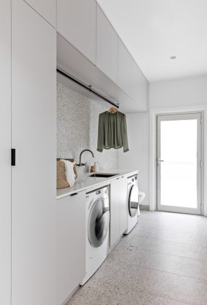 Tonal terrazzo laundry: Modern laundry renovation with a retro twist