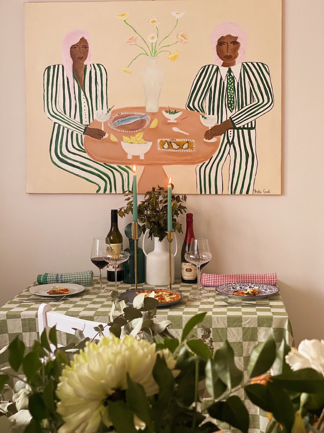 Dining table setting with artwork above