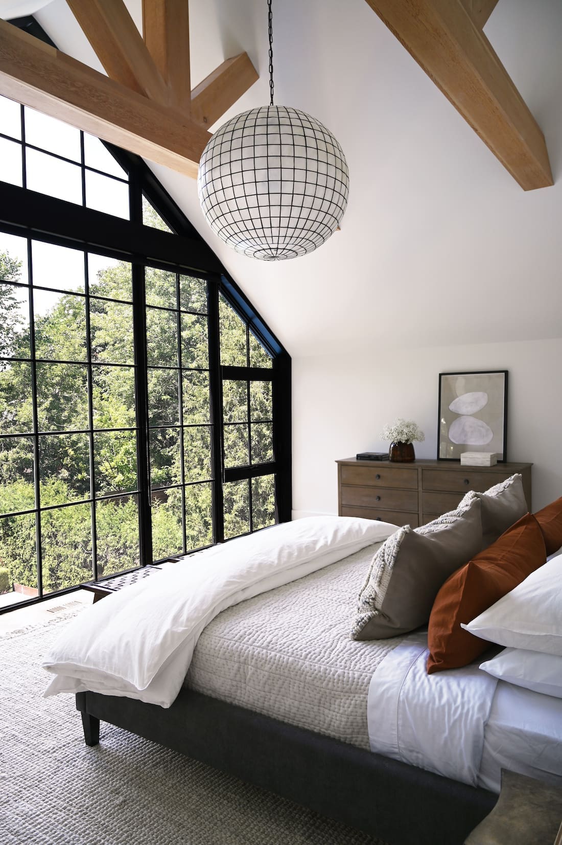 Bed facing floor to ceiling window