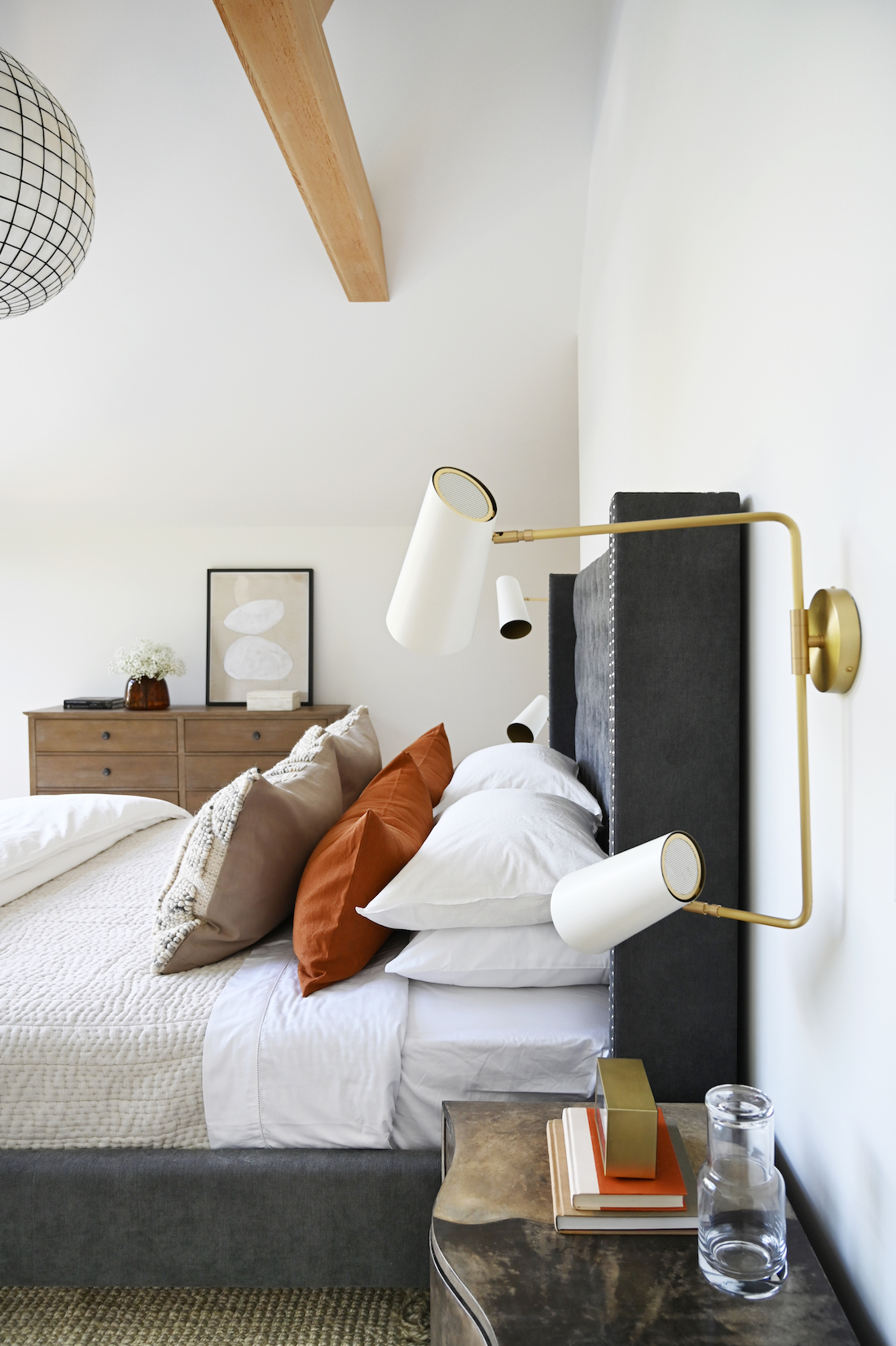 Bedroom with gold metal wall sconce