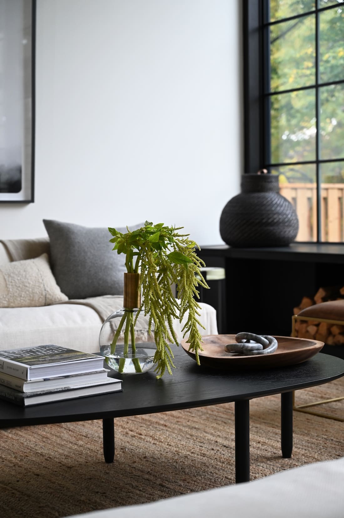 Coffee table with glass vase and stack of books