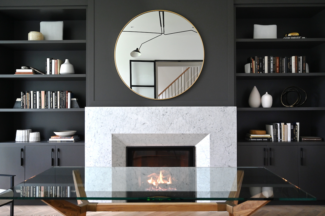 Fireplace with round mirror above