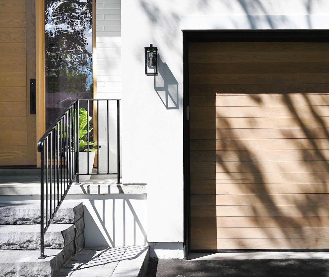 Steps to the front door and wooden garage door