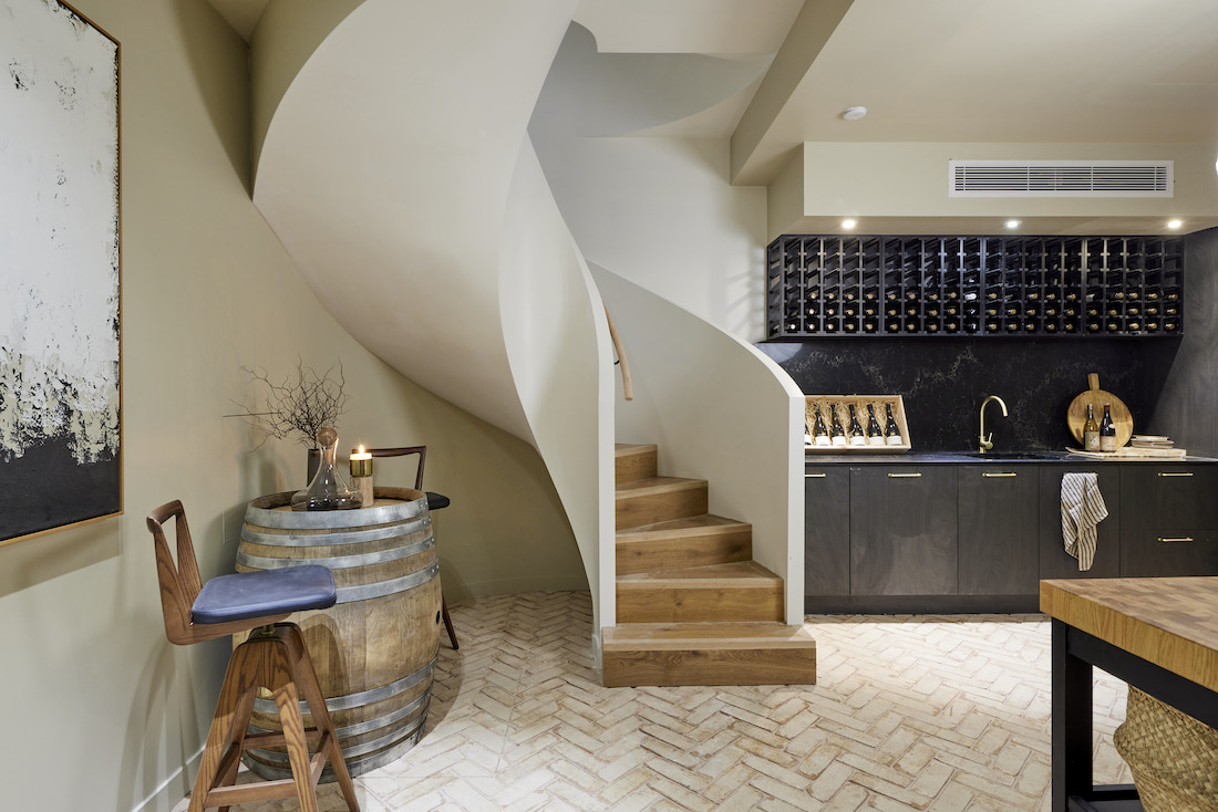 Basement wine room with curved staircase