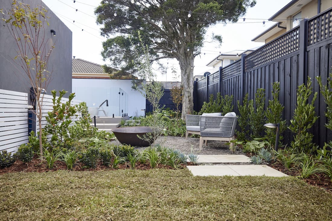 Grassed area with seating by fire pit