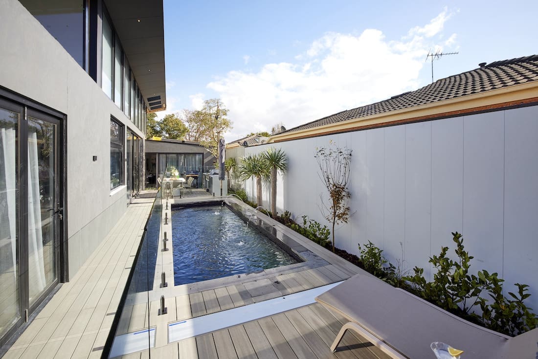 Side of home with long skinny pool