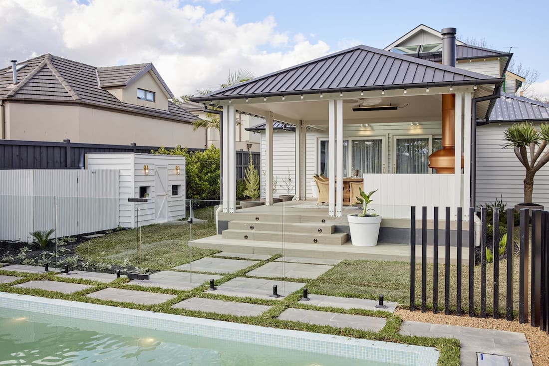 Pavers and grassed space leading up to covered cabana space