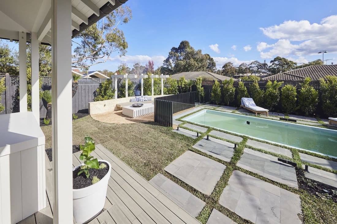 Pavers leading up to pool with fire pit seating space