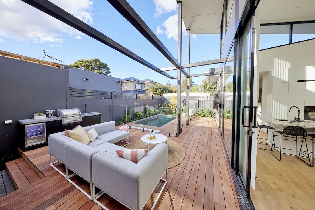 Black framed pergola on outdoor deck