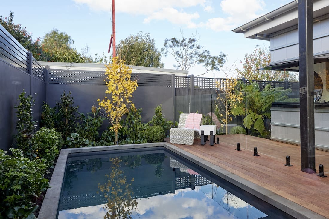 Pool with wooden deck and sun lounger