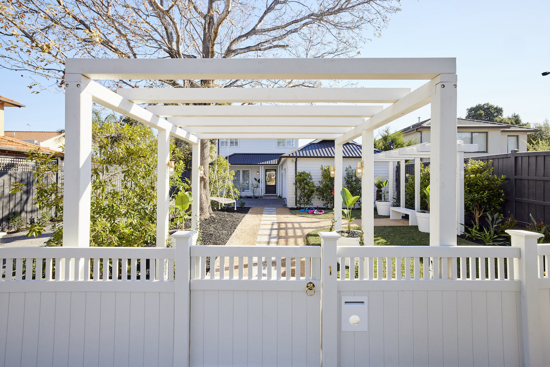 White arbour and fence to home