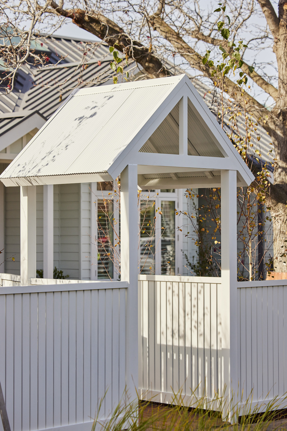 White picket fence with gable entrance