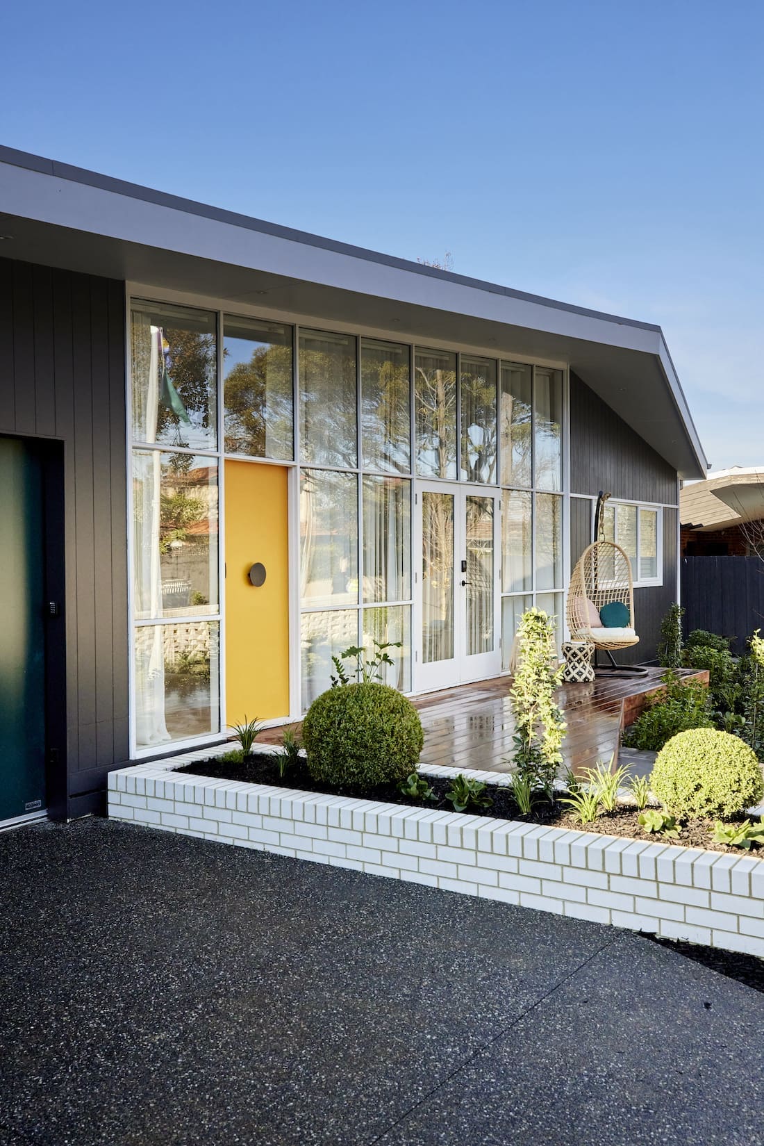 Wall of windows with yellow front door