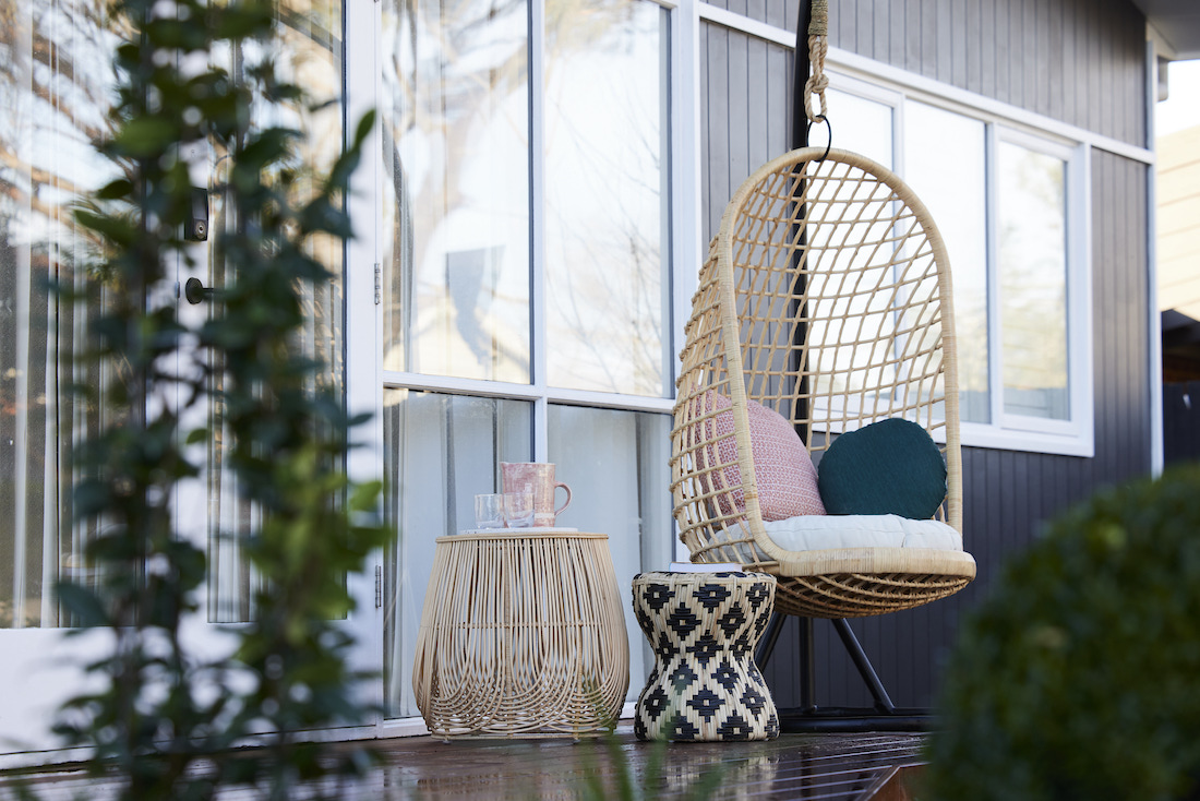 Hanging cane chair on front porch