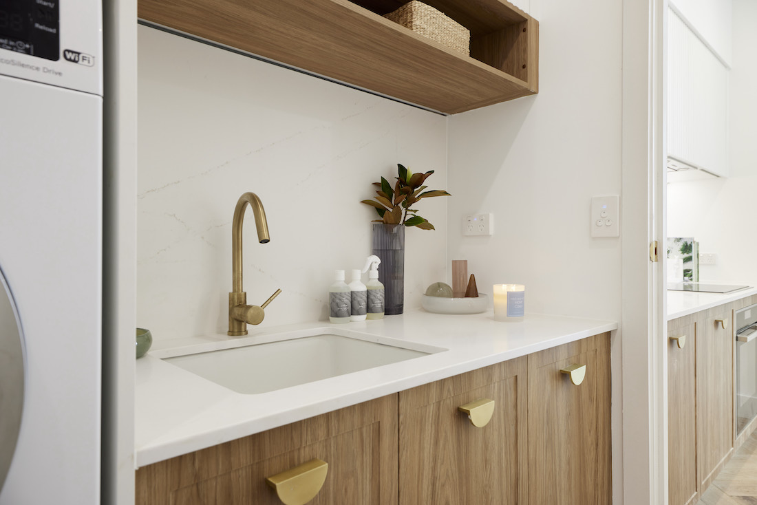Laundry with timber cabinetry and open shelf