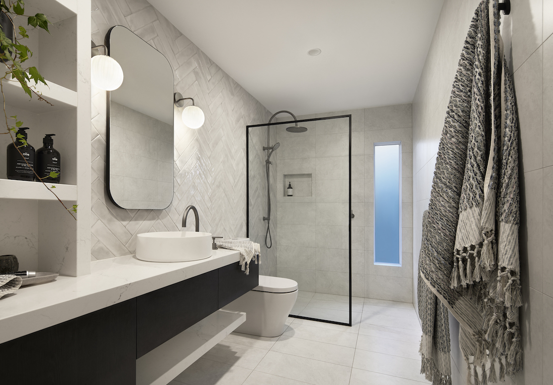 Grey bathroom with curved rectangular mirror