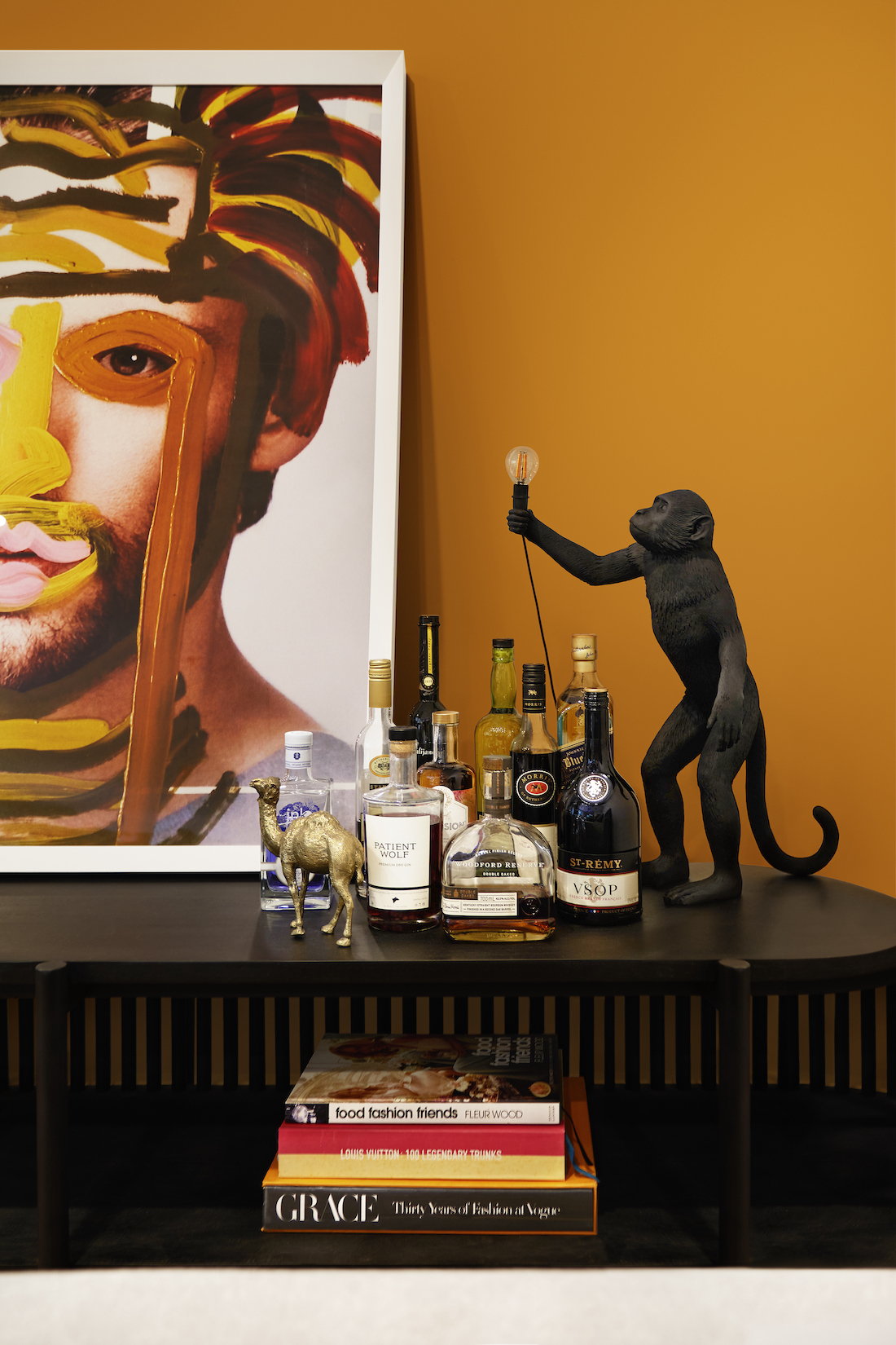 Monkey lamp in bar area with mustard yellow wall