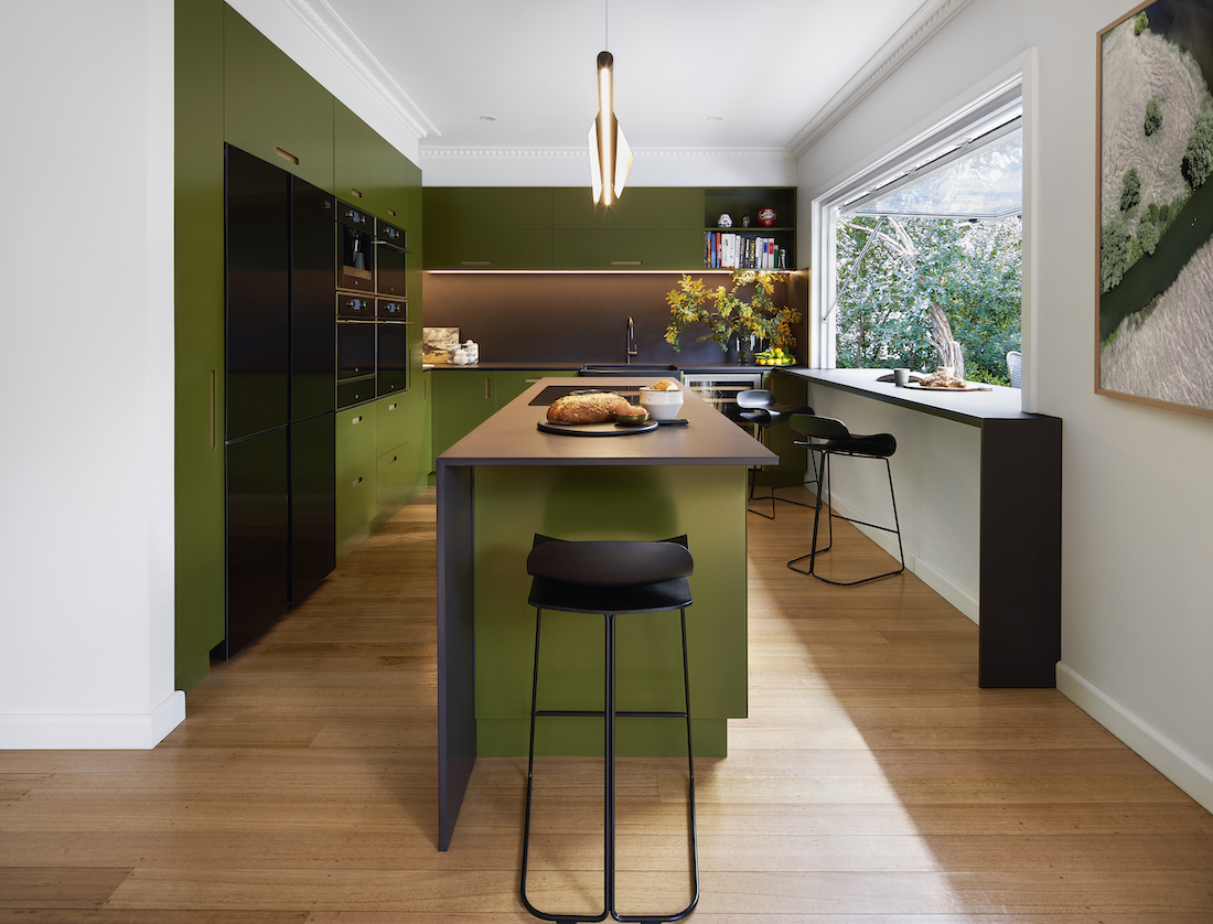 Green kitchen with timber flooring