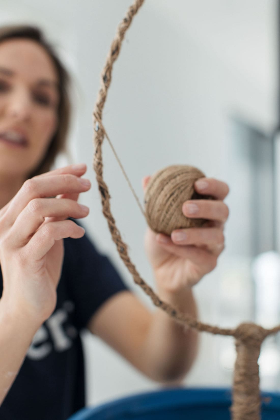 Wrapping metal ring in twine for DIY plant trellis