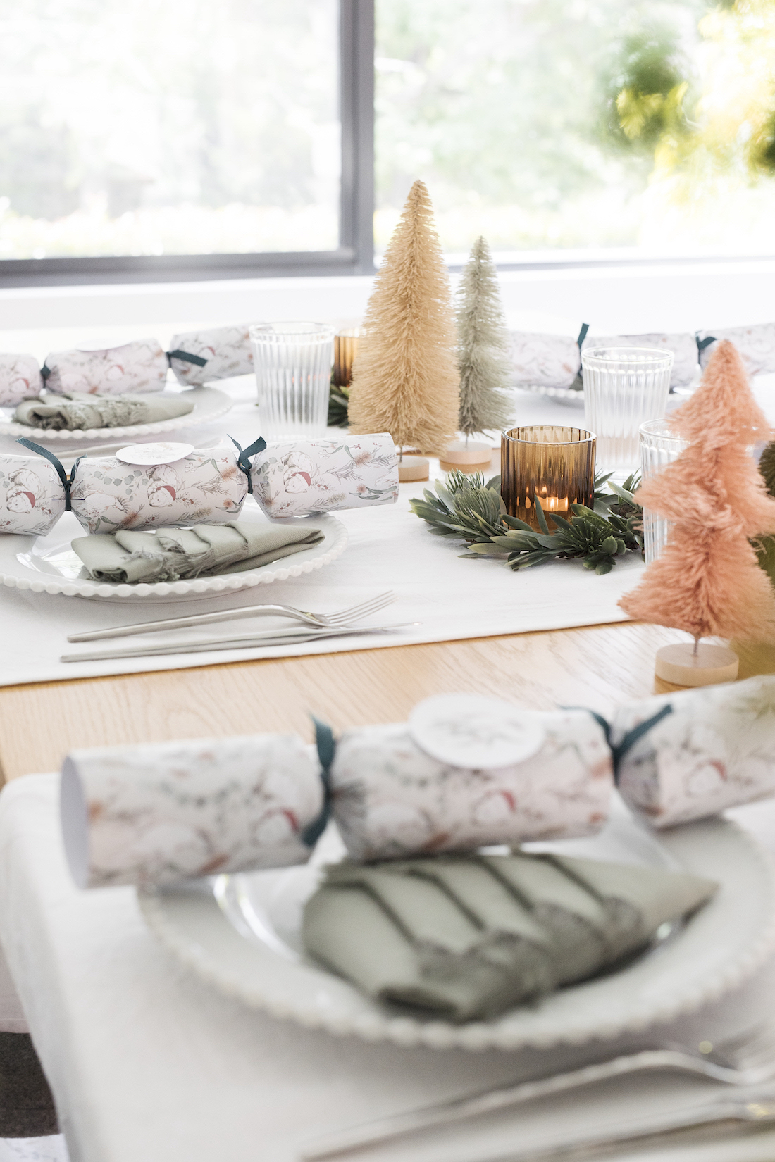 Christmas crackers and Christmas tree napkins on festive table