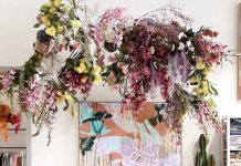 Floral display hanging from ceiling with Sarah Leslie artwork