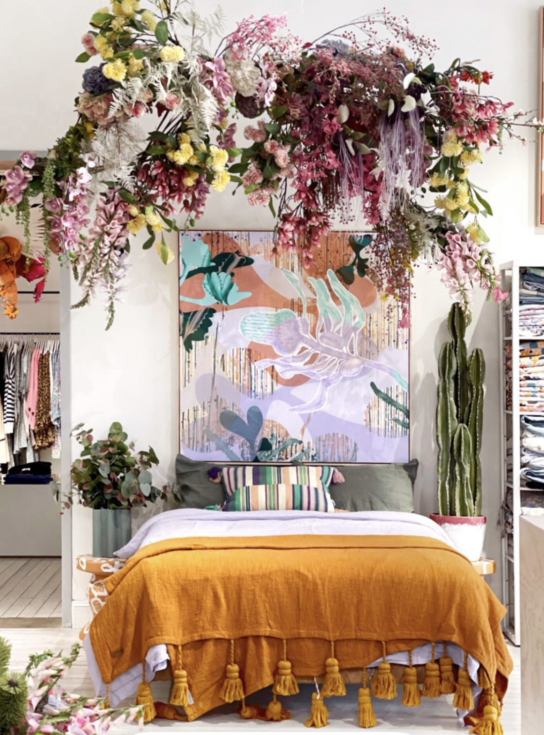 Floral display hanging from ceiling with Sarah Leslie artwork