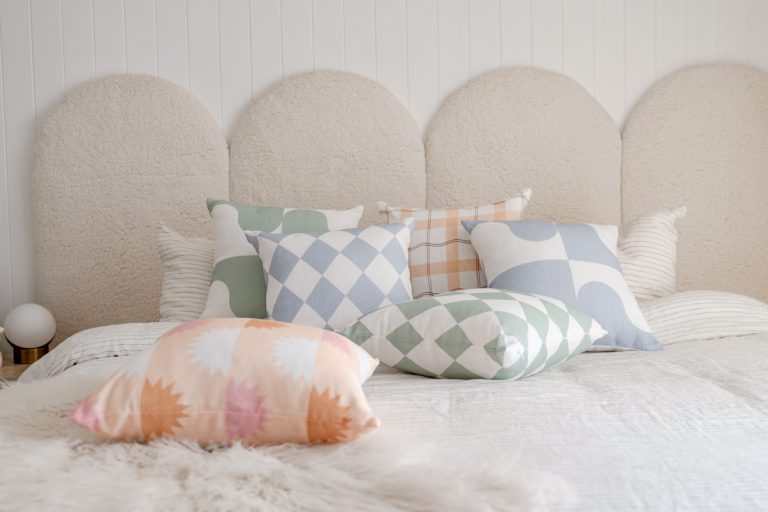 Arched Boucle bedhead with The Tartan Space cushions