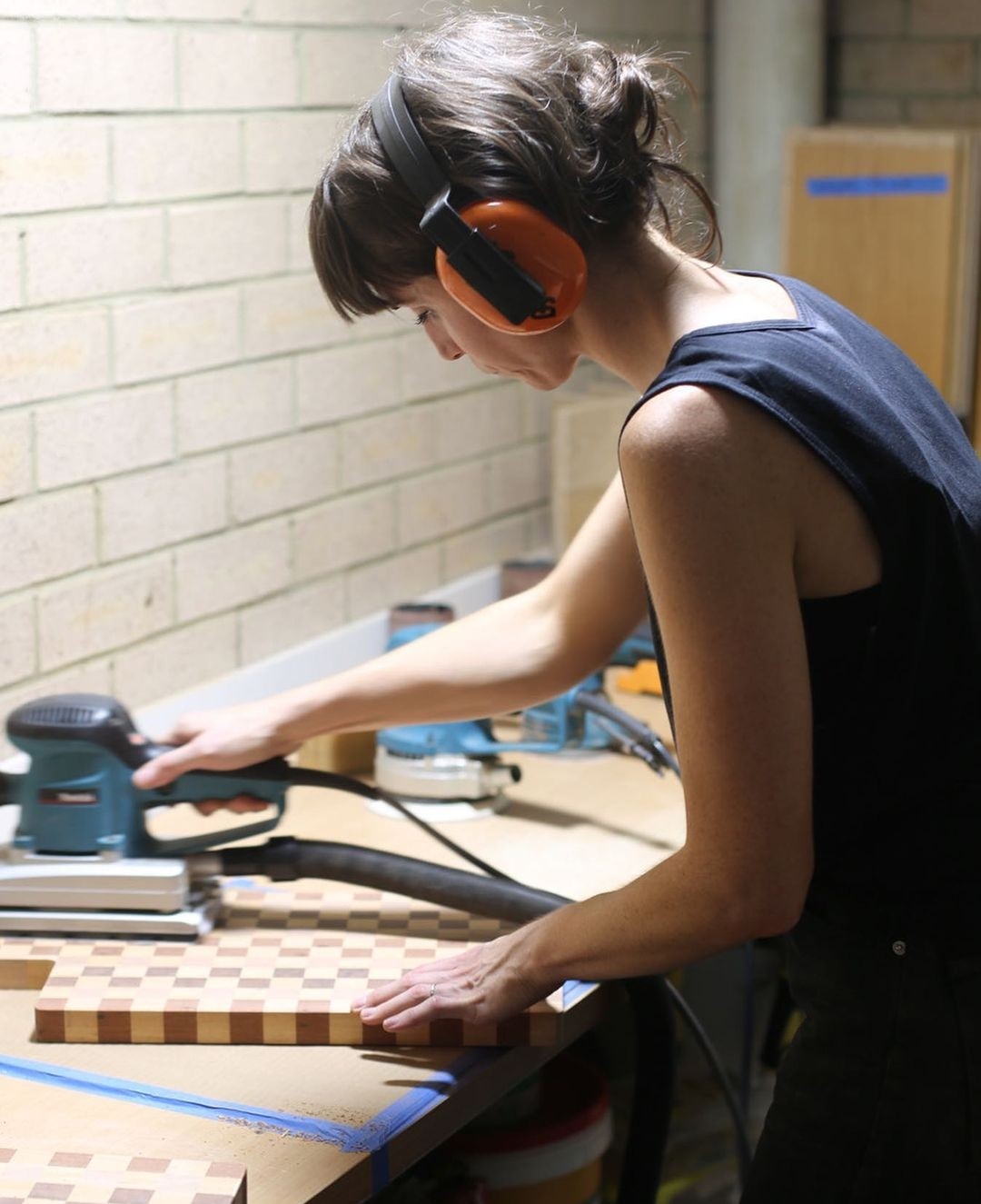 Sarah Ford from TS Makers sanding a handmade board
