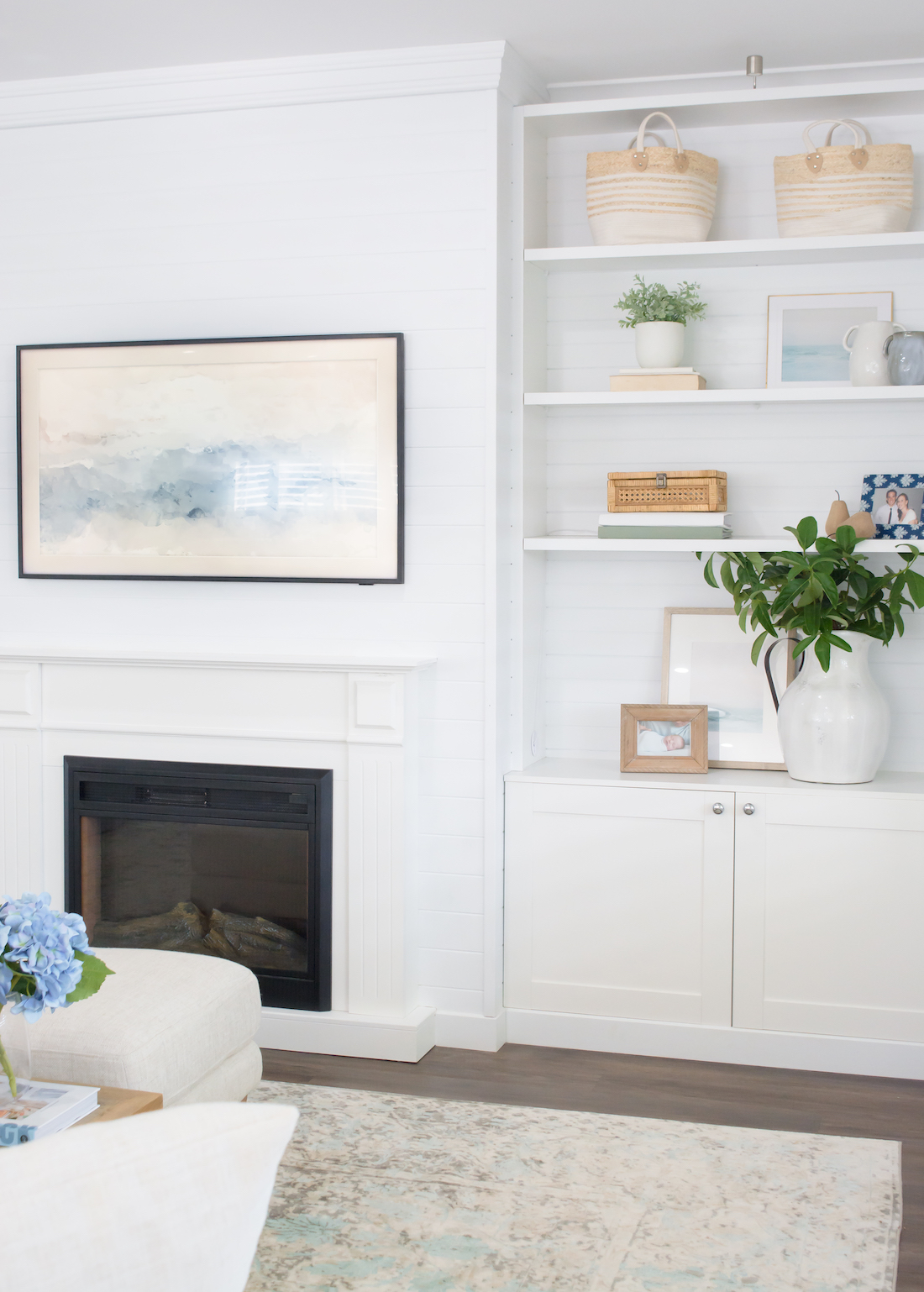 White living room with fireplace and bookshelf _ classic coastal home