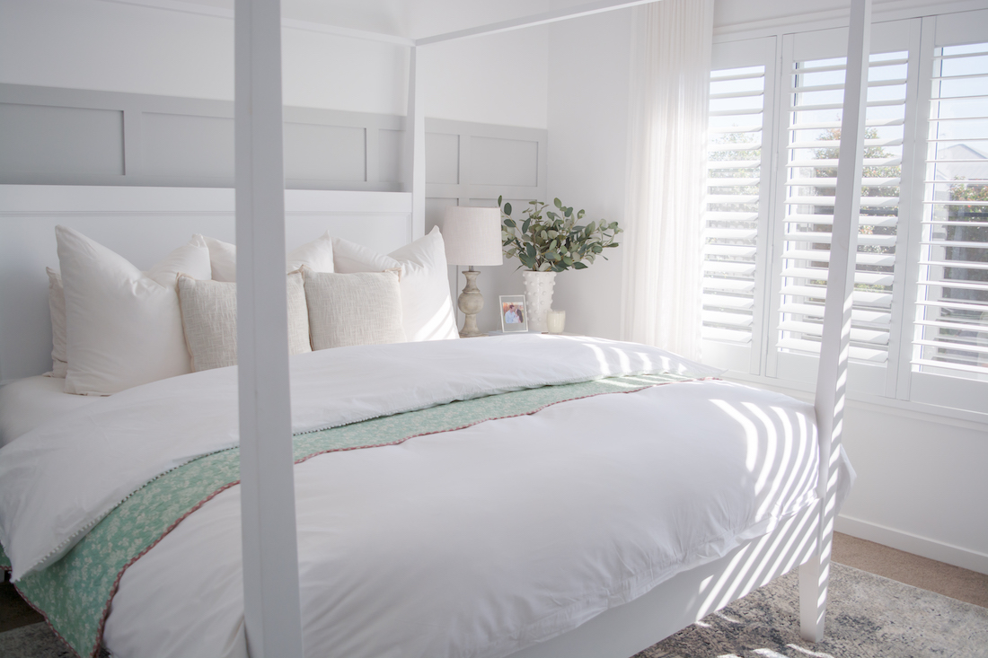 White master bedroom with poster bed