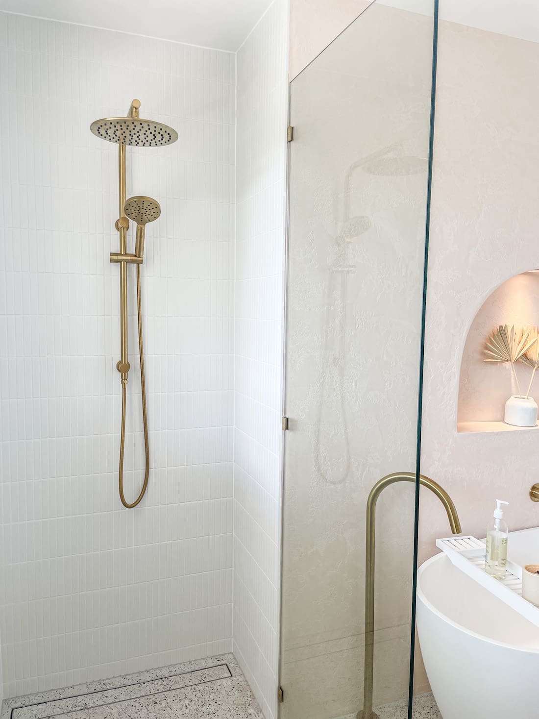 brass showerhead in coastal bathroom