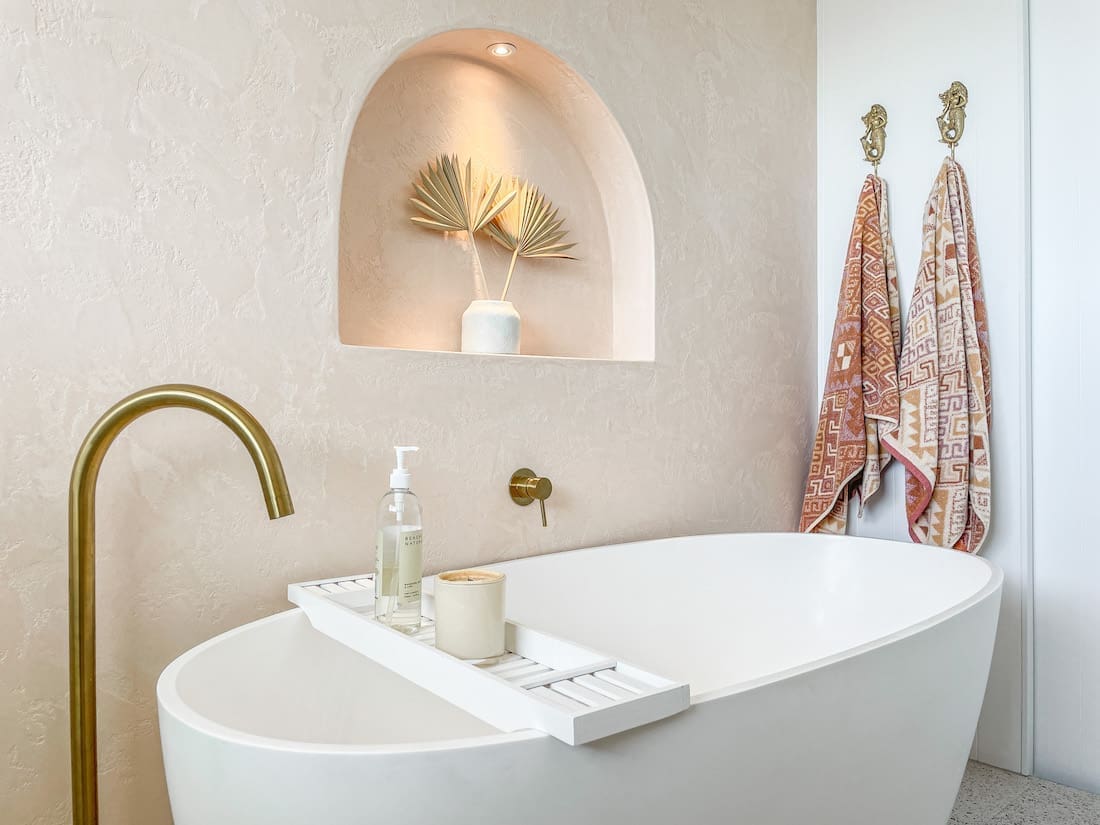 brass tapware and white tub _ earthy coastal bathroom