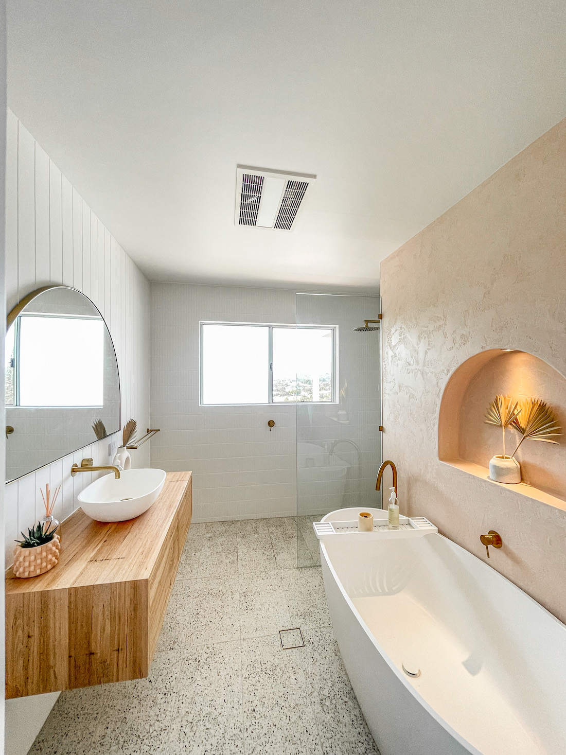 coastal bathroom with tub and timber vanity