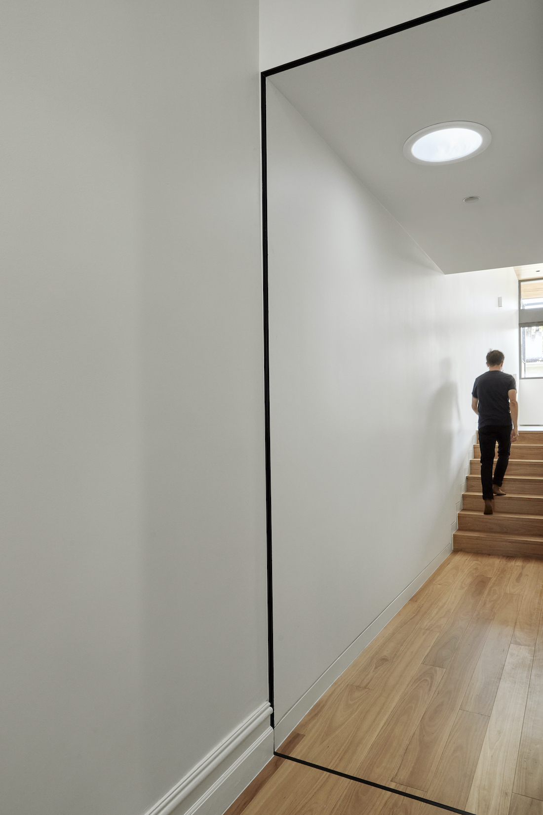 white hallway with timber floors