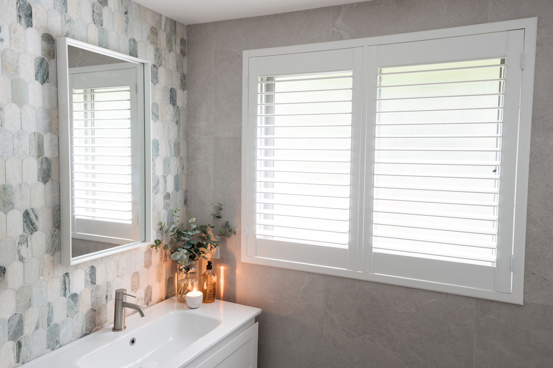 white plantation shutters on grey tile wall _ ming green marble bathroom