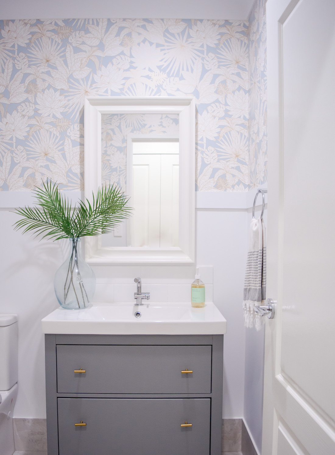 white powder room with blue floral wallpaper