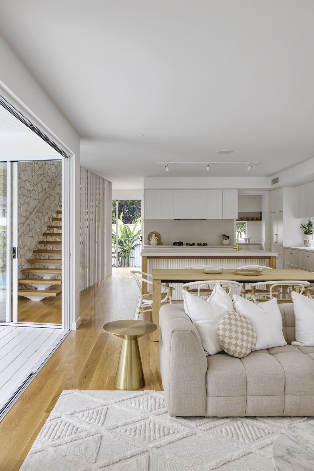 Living room with open doors to outdoor dining at Tawarri house