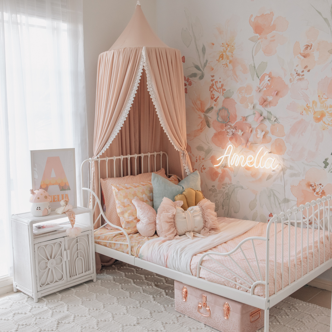 pink girls bedroom with white metal frame bed