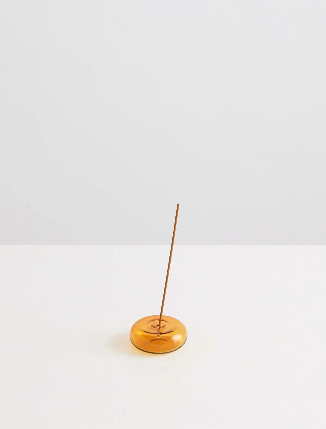 Amber glass pebble incense holder