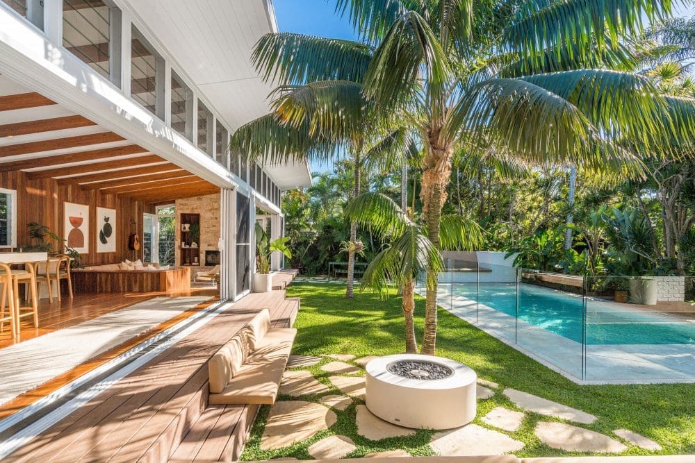 Coastal style home with concrete fire pit