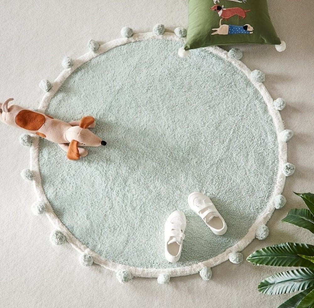 Sage green pom pom rug from Adairs