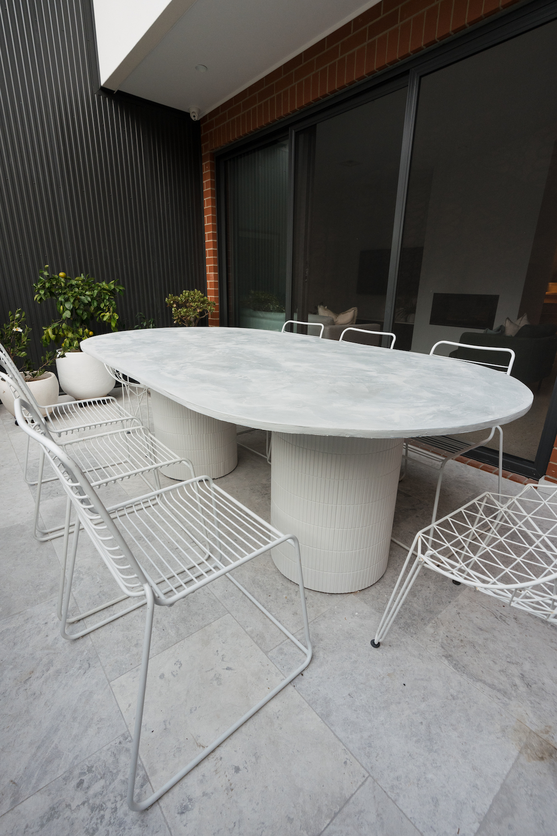 concrete top table with tiled legs