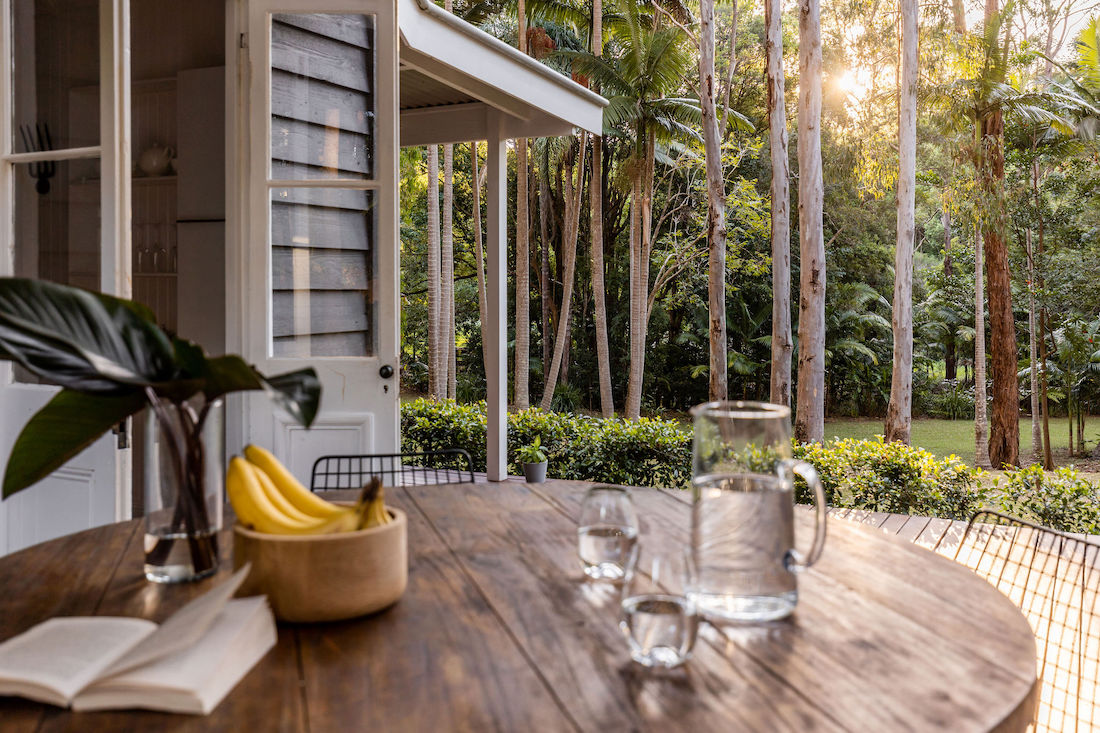 Outdoor dining with view to gardens at Fig Tree Villa Byron Bay