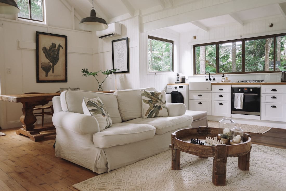 Sofa and coffee table in open plan living dining and kitchen at Fig Tree Villa Byron Bay