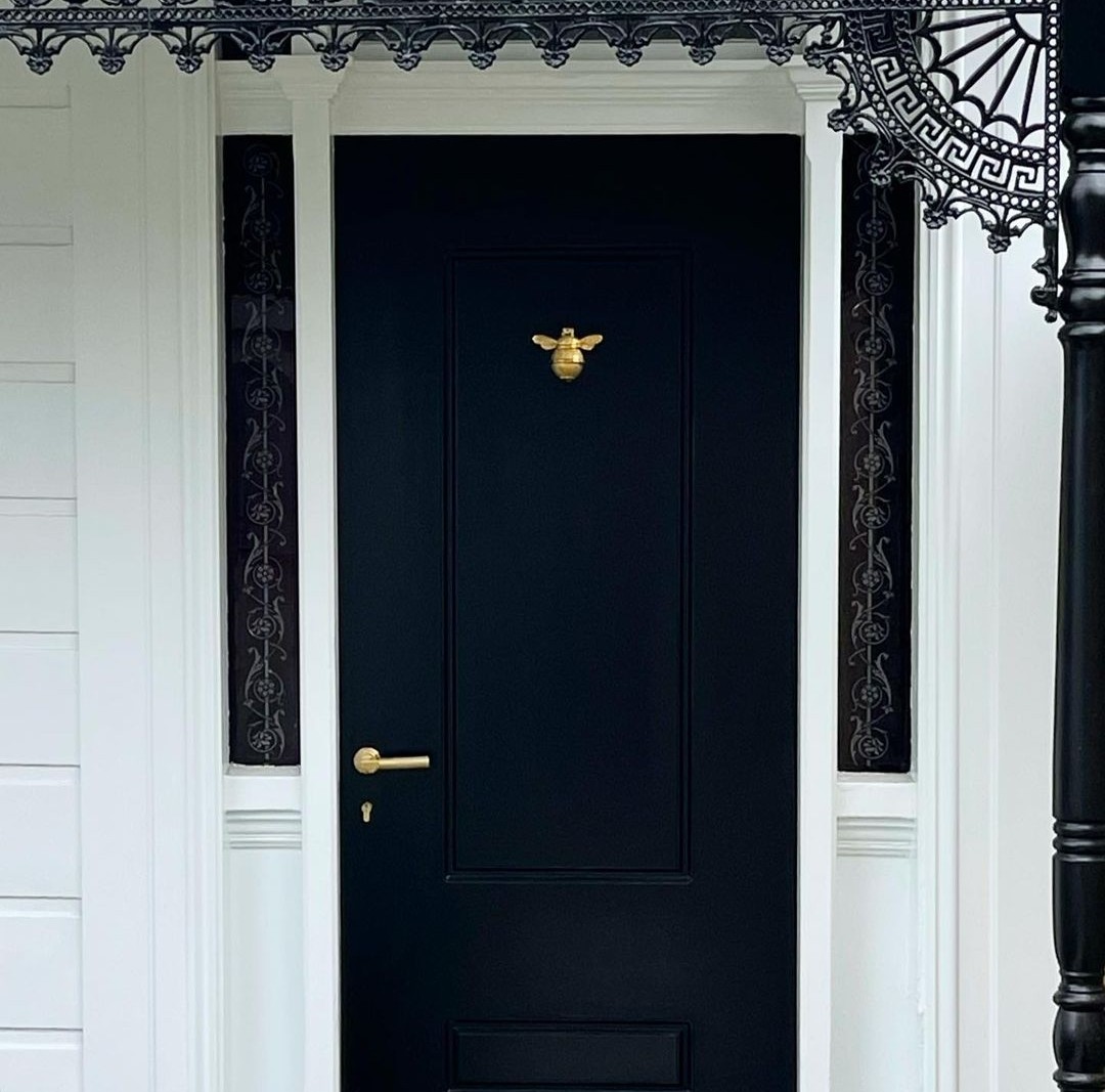 Black front door with bee knocker